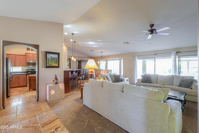 living room with ceiling fan and vaulted ceiling