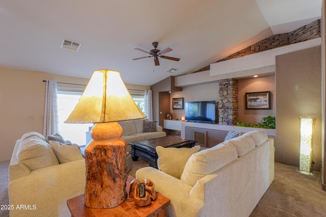 carpeted living room with ceiling fan and vaulted ceiling