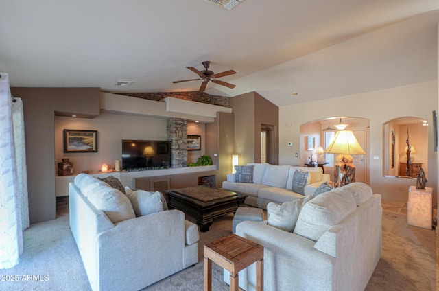 living room with light colored carpet, ceiling fan, and vaulted ceiling