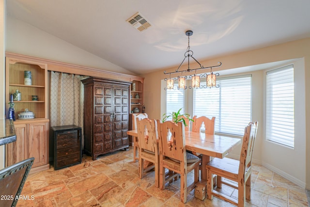 dining room featuring lofted ceiling