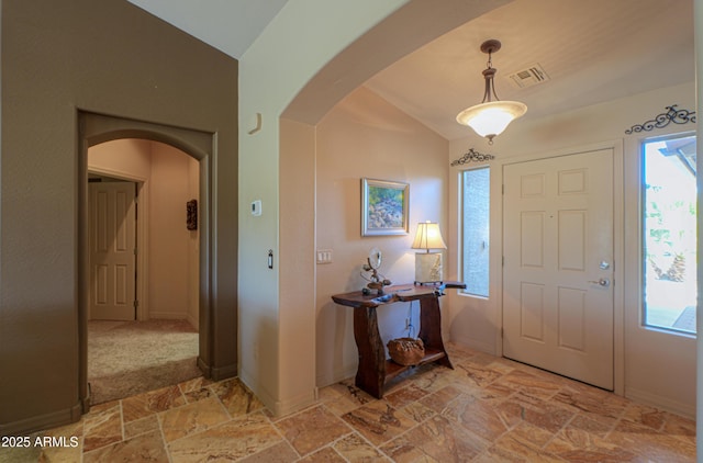 entryway with vaulted ceiling and plenty of natural light