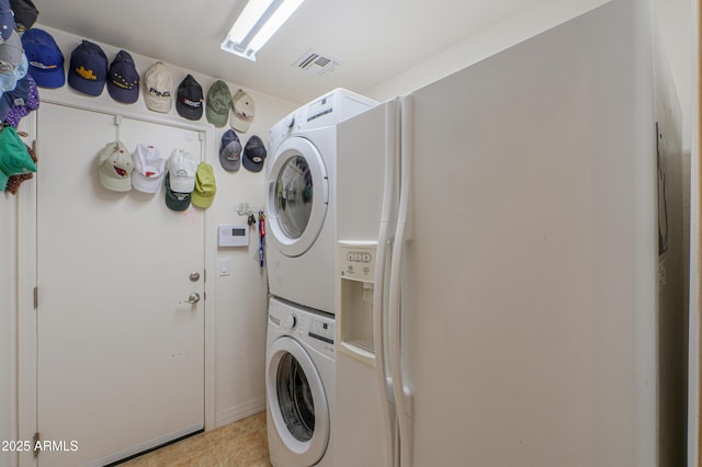 washroom with stacked washer and clothes dryer