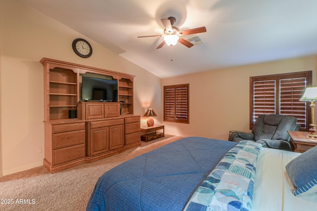 bedroom with ceiling fan, vaulted ceiling, and light colored carpet