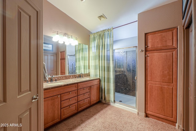 bathroom with lofted ceiling, a shower with shower door, and vanity