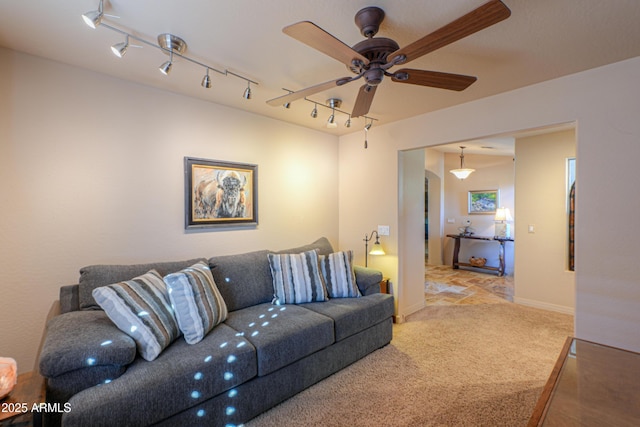 carpeted living room with ceiling fan