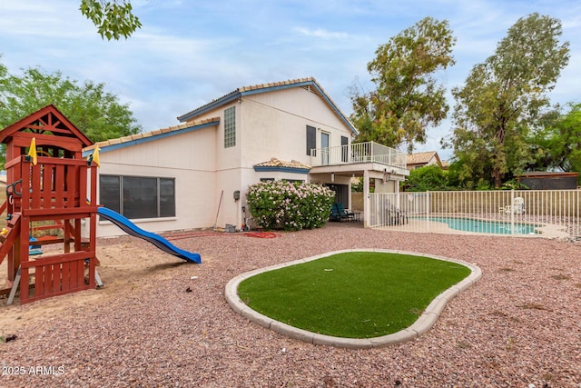 view of play area with fence and a fenced in pool