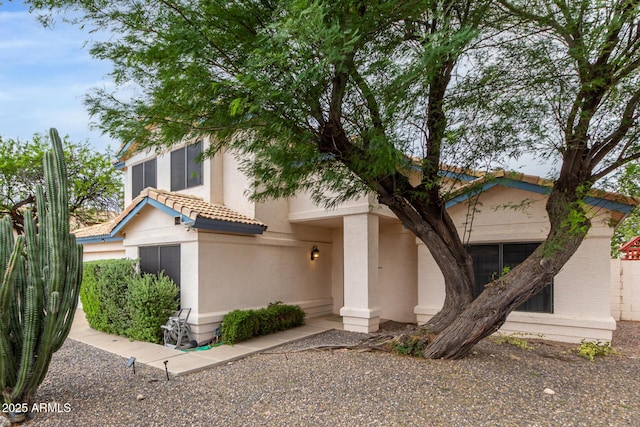 view of front of house featuring a tile roof and stucco siding