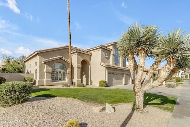 mediterranean / spanish-style home featuring concrete driveway, an attached garage, a tile roof, and stucco siding