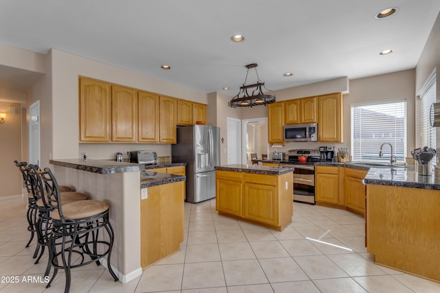 kitchen with a breakfast bar, stainless steel appliances, recessed lighting, light tile patterned flooring, and a peninsula