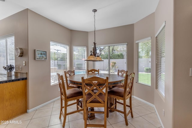 dining space featuring baseboards and light tile patterned floors