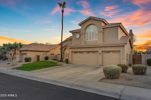 mediterranean / spanish-style house featuring a garage, a tile roof, driveway, and stucco siding