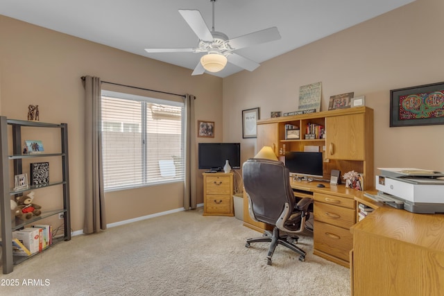 office space featuring light colored carpet, ceiling fan, and baseboards