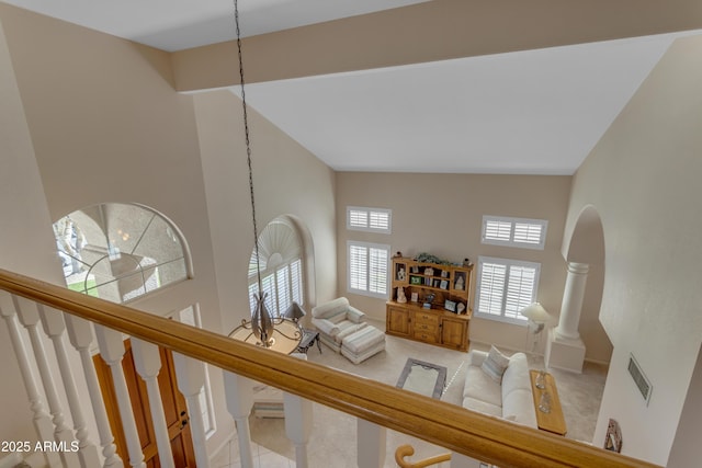 living room featuring visible vents, carpet flooring, high vaulted ceiling, baseboards, and stairs