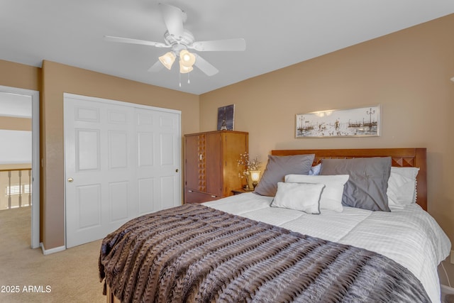 bedroom featuring baseboards, a closet, a ceiling fan, and light colored carpet