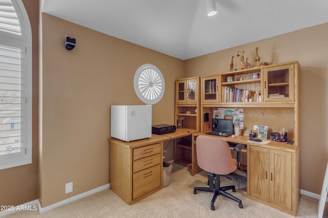 office featuring light carpet and baseboards