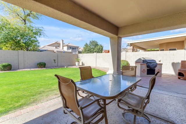 view of patio / terrace with outdoor dining area, area for grilling, and a fenced backyard