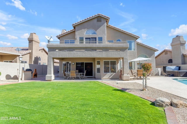 rear view of house with a lawn, a patio area, a fenced backyard, and stucco siding