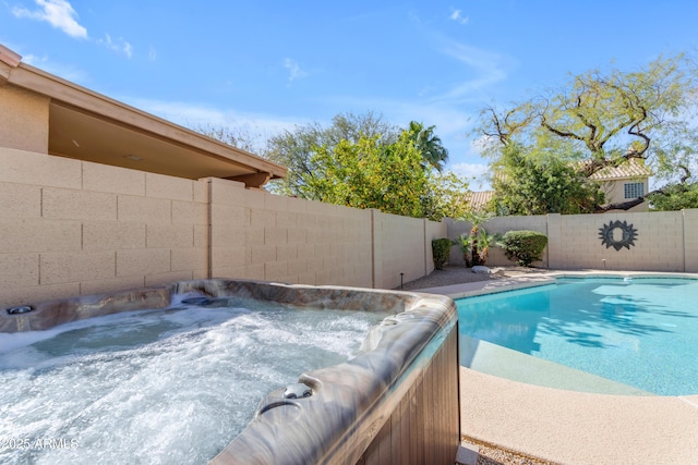 view of pool with a fenced in pool, a fenced backyard, and a hot tub