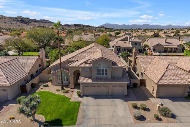 drone / aerial view featuring a residential view and a mountain view