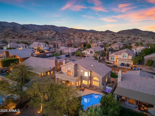 aerial view at dusk with a residential view and a mountain view