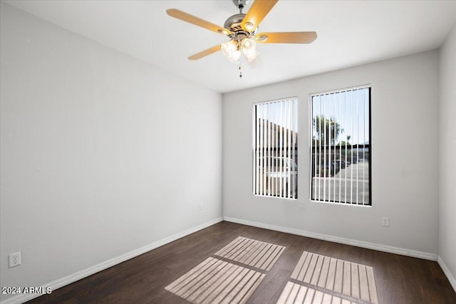 unfurnished room with ceiling fan and dark hardwood / wood-style flooring