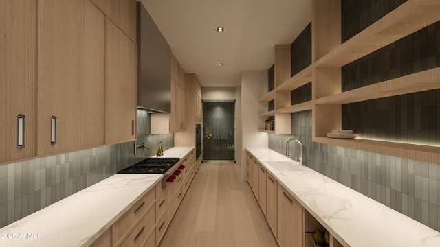 kitchen with light brown cabinetry, sink, tasteful backsplash, and light hardwood / wood-style floors