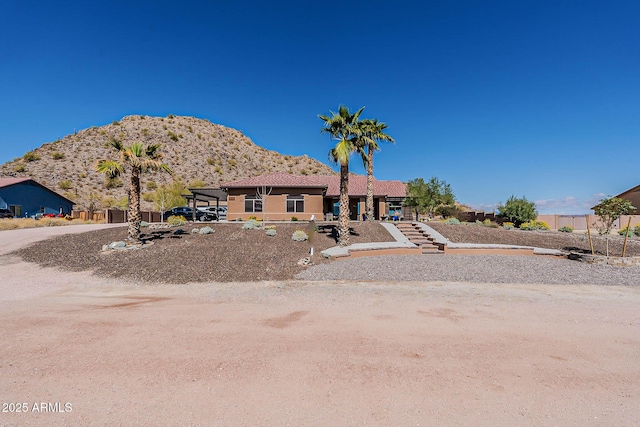 view of front of property featuring a mountain view and stairs