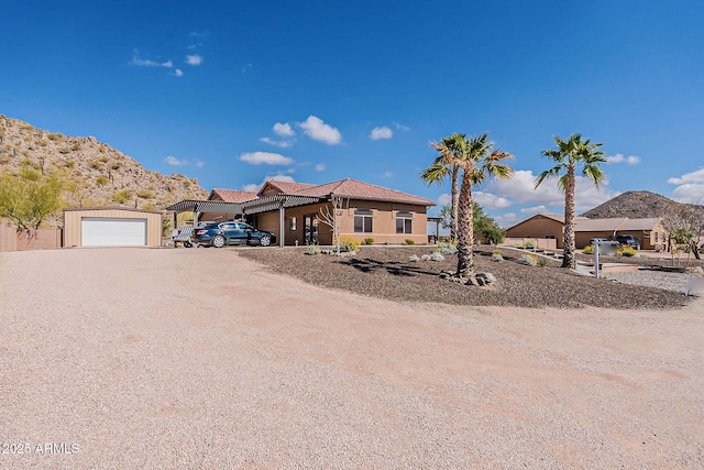 view of front of property with dirt driveway and a mountain view