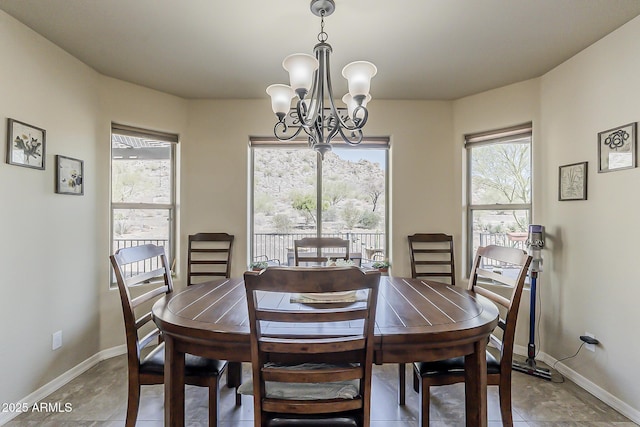 dining room with an inviting chandelier and baseboards