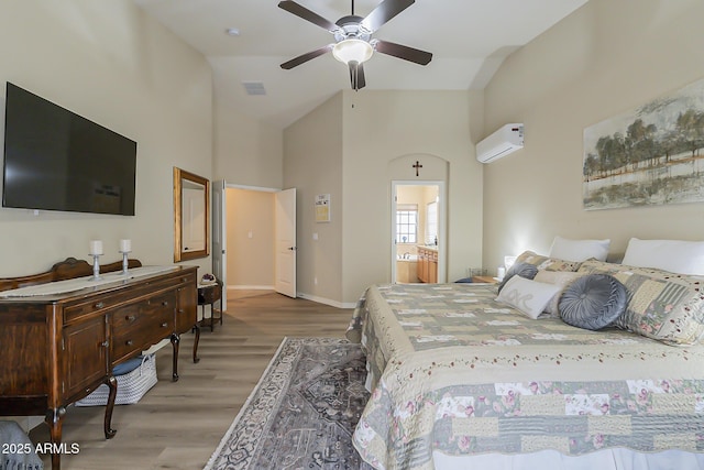 bedroom featuring high vaulted ceiling, a wall unit AC, wood finished floors, visible vents, and baseboards