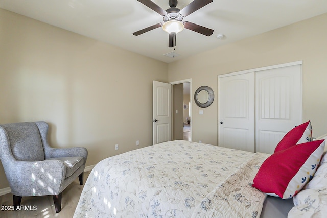 bedroom featuring ceiling fan, a closet, and baseboards