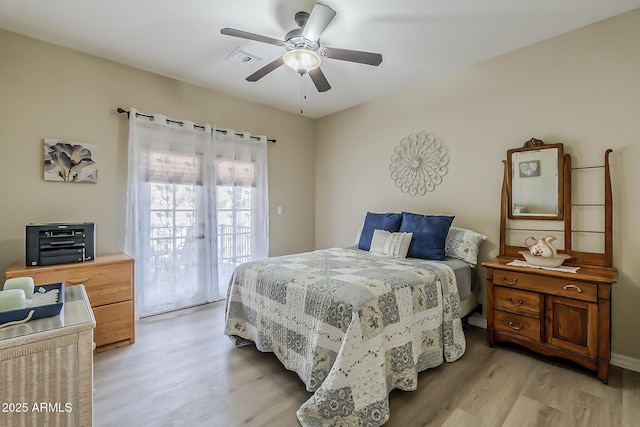 bedroom with access to exterior, visible vents, light wood-style floors, and ceiling fan