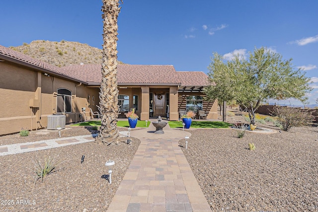 back of property featuring a patio area, a tile roof, cooling unit, and stucco siding