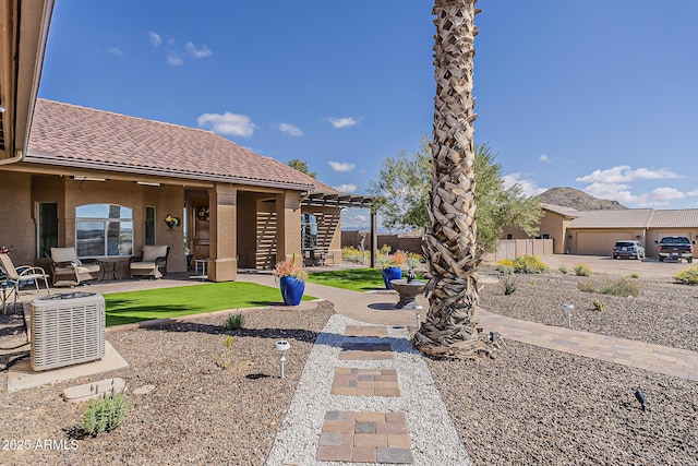 view of yard featuring a patio, central AC unit, and fence