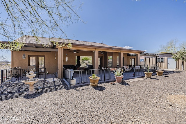 back of property featuring ceiling fan, french doors, a patio area, and stucco siding