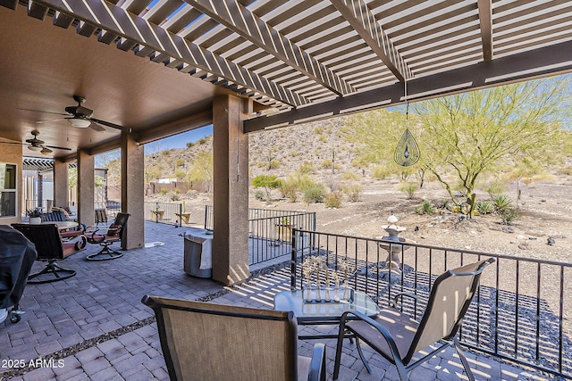 view of patio / terrace with ceiling fan, fence, and a pergola