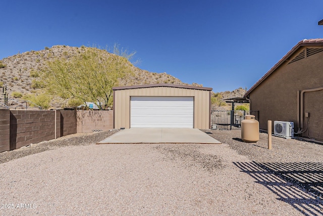 detached garage with ac unit and fence