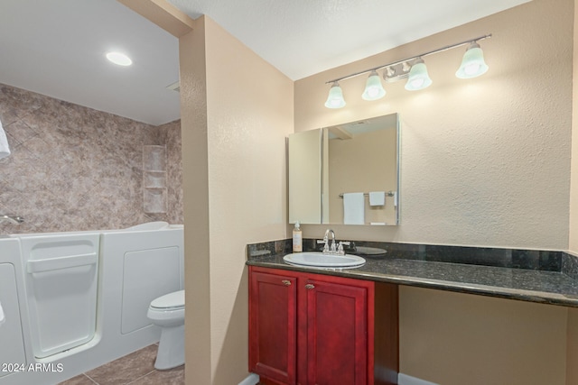 bathroom with vanity, toilet, a tub, and tile patterned floors