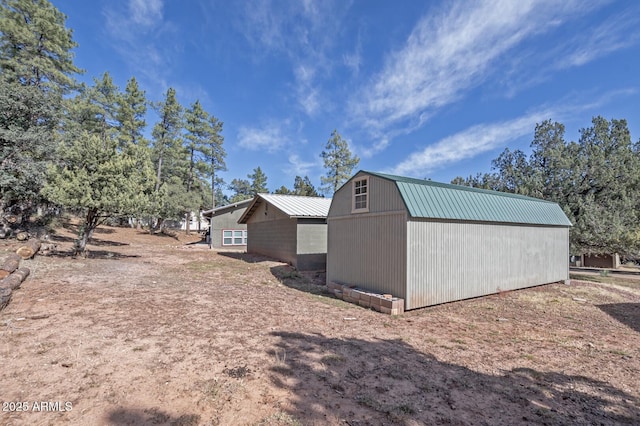 4090 N Cherri Lynn Dr, Pine, AZ 85544 - view of home's exterior with metal roof, a gambrel roof, and an outbuilding