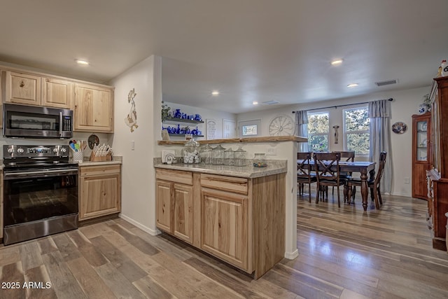 4090 N Cherri Lynn Dr, Pine, AZ 85544 - kitchen featuring stainless steel microwave, black range with electric cooktop, light brown cabinetry, a peninsula, and wood-type flooring