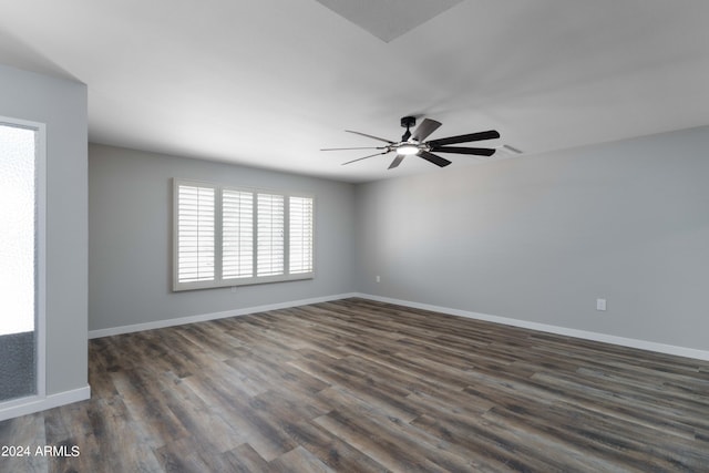 unfurnished room featuring ceiling fan and dark wood-type flooring