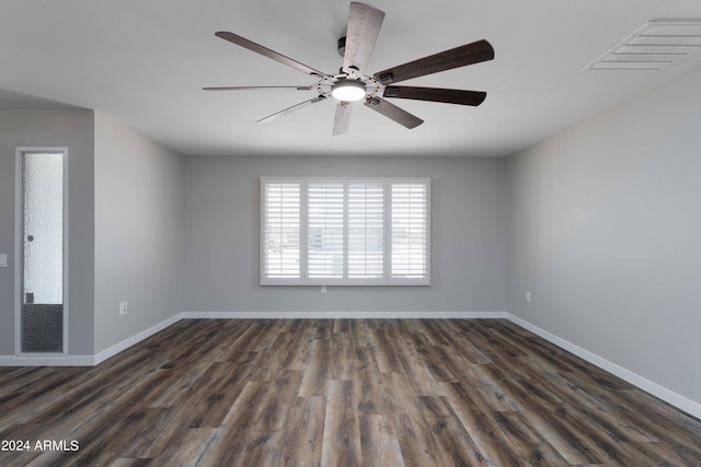 spare room with ceiling fan and dark wood-type flooring