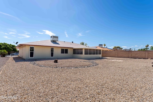 rear view of house with a sunroom and cooling unit