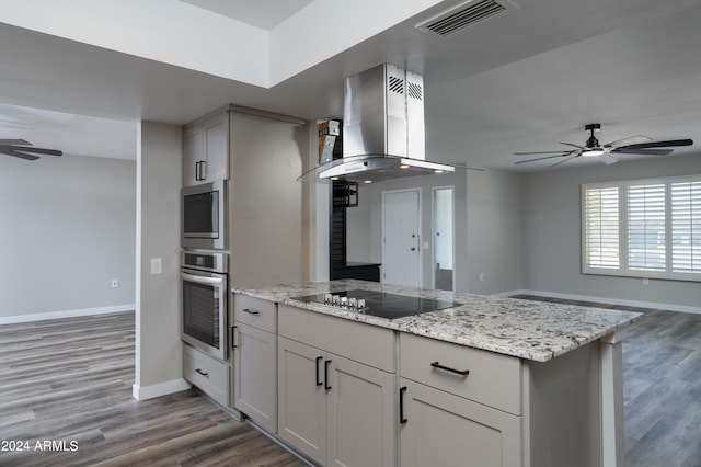 kitchen with black electric stovetop, light stone counters, dark wood-type flooring, and exhaust hood