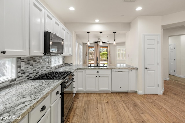 kitchen with light wood-type flooring, white cabinets, ceiling fan, high end stainless steel range, and dishwasher