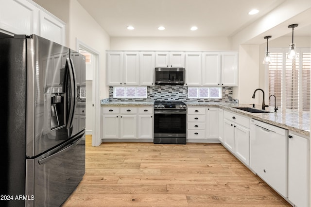 kitchen featuring light wood-type flooring, stainless steel appliances, white cabinetry, and sink