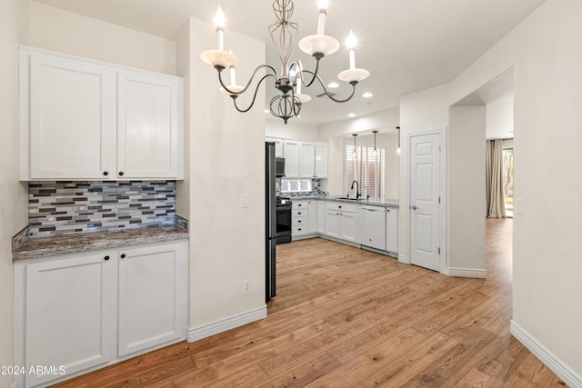 kitchen with stainless steel appliances, decorative light fixtures, light hardwood / wood-style flooring, a chandelier, and white cabinetry