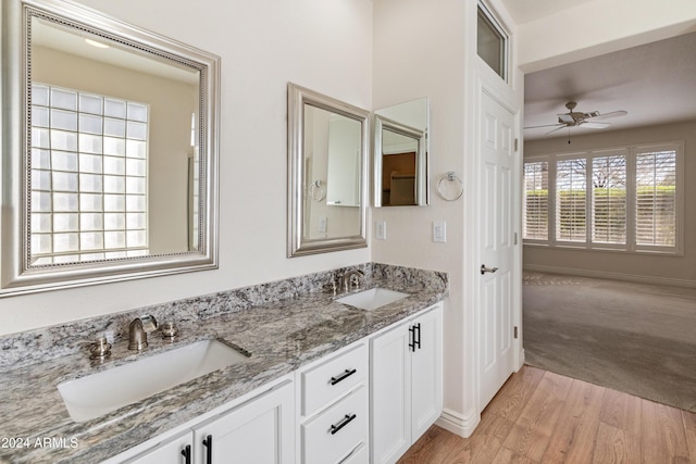 bathroom featuring wood-type flooring, vanity, and ceiling fan