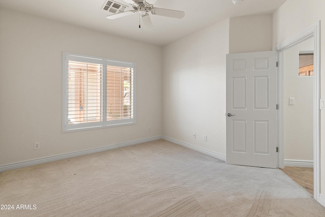 carpeted spare room with ceiling fan