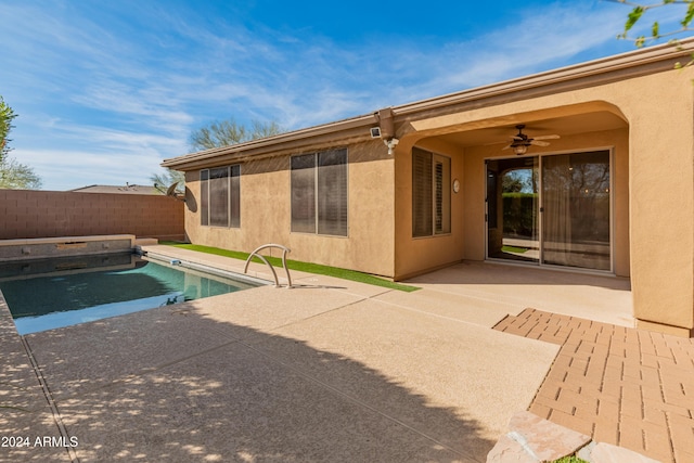 view of swimming pool with ceiling fan and a patio area